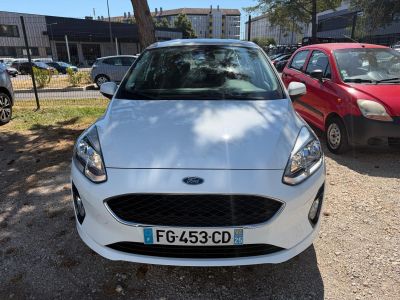 the front of a white ford fiesta parked in a parking lot