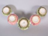 four candles that are sitting on a white table