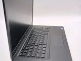 a laptop that is open on a white surface