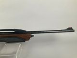 a rifle with a wooden barrel on a white background