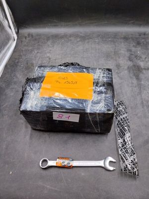 a box of tools sitting on the floor next to a pair of wrenches