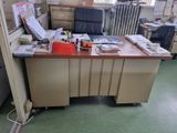 a desk with a lot of clutter on it in a room