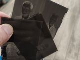 a hand holding a black and white photo of a man