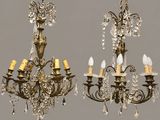 two antique chandeliers hanging from the ceiling in a room