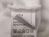 a close up of a label on a white shirt that says wash with like colors