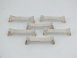 six antique cast iron door handles on a white surface