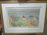 painting of a landscape with houses and trees in a gold frame on a table