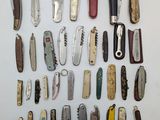 many different types of pocket knives on the table