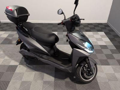 a scooter that is parked on a checkered floor