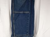 the jeans are hanging on a hanger on a white sheet