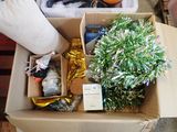 a cardboard box filled with christmas decorations on the floor