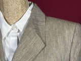 a mannequin wearing a suit and tie on a mannequin stand