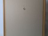 an empty picture frame with a hole in the middle of it