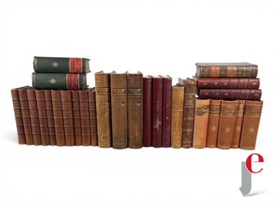 several old books stacked on top of each other on a white surface