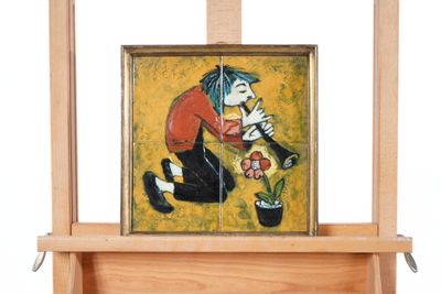 a painting on a easel with a painting of a man