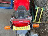 a red motorcycle that is parked in a garage