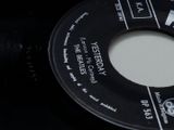 a black and white label on a record on a black surface