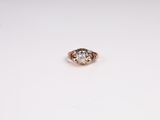 a close up of a diamond ring on a white surface