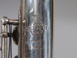 an image of a silver plated instrument with a bell on it