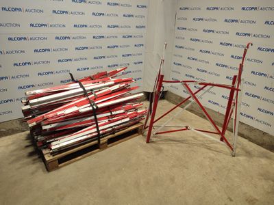 a pile of skis sitting on a pallet in front of a wall