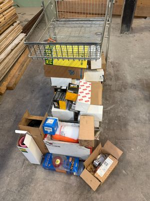 a cart full of boxes and other items in a warehouse