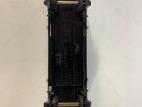 a small black train on a white surface
