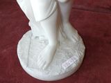 a white figurine of a woman holding a baby