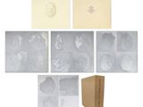 a group of photographs and a box of papers on a white surface