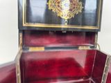 a red suitcase with a gold decoration on the inside