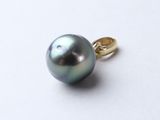 a black pearl on a gold ring on a white surface