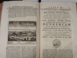 an open book with a picture of a town in the middle of it
