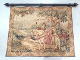a tapestry hanging on the wall with a picture of a man on a horse