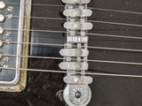 a close up of a guitar that is on a table