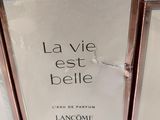 three bottles of lancomme la vie est belle perfume sitting on a table