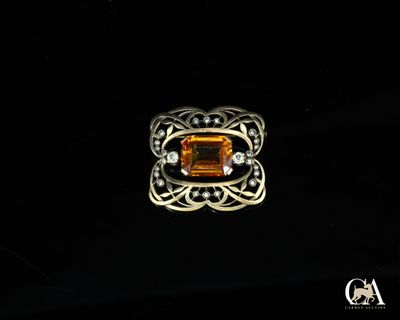 une image représentant une bague ornée d'une citrine entourée de diamants