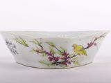 a white bowl with a yellow bird on it