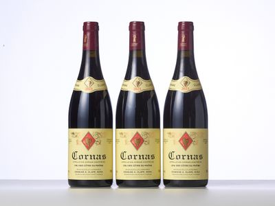 three bottles of red wine sitting on top of a table