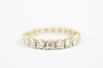 a diamond eternity ring in yellow gold
