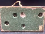 a green box with holes in it on a table