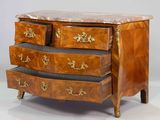 a small chest of drawers with marble top