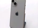 a white iphone sitting on a stand on a white surface