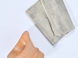 a small metal object next to a small wooden object