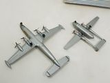 two model airplanes sitting on a table next to each other