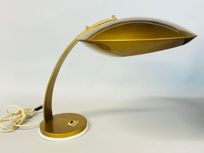an image of a gold desk lamp on a white surface
