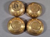 three gold vases sitting on top of a table with writing on them
