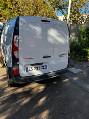 a white van that is parked on the side of the road