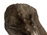 a bronze sculpture of a horse head on a white background
