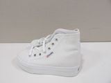 a pair of white shoes on a white surface