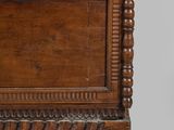 an old wooden chest sitting on top of a white surface