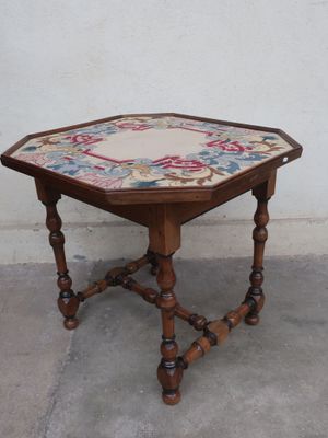 a small wooden table with a floral design on it